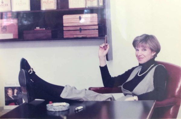 A woman with her feet up on her desk